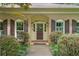 Charming brick home with inviting front entrance framed by lush landscaping at 11190 Hembree Springs Dr, Roswell, GA 30076