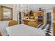 Bright kitchen with a chandelier, black and white tile floors, wood cabinets and stainless steel appliances at 11190 Hembree Springs Dr, Roswell, GA 30076
