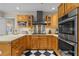 Well-equipped kitchen with stainless steel appliances, double ovens, and custom wood cabinets at 11190 Hembree Springs Dr, Roswell, GA 30076