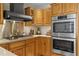 A kitchen featuring wood cabinets, stainless steel appliances, granite countertops, and a tile backsplash at 11190 Hembree Springs Dr, Roswell, GA 30076