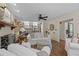 Bright living room with wood floors, fireplace, ceiling fan, and white bookshelves for storage at 11190 Hembree Springs Dr, Roswell, GA 30076