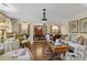 Sophisticated living room with hardwood floors, ornate lighting, and elegant furniture arrangement at 11190 Hembree Springs Dr, Roswell, GA 30076