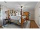 Spacious main bedroom featuring a four-poster bed, hardwood floors and a ceiling fan at 11190 Hembree Springs Dr, Roswell, GA 30076