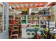 Well-organized outbuilding interior with shelves, storage containers, and various household items at 11190 Hembree Springs Dr, Roswell, GA 30076