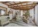Relaxing sunroom with whitewashed ceiling, comfy seating and bright natural light at 11190 Hembree Springs Dr, Roswell, GA 30076