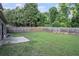 Large fenced-in backyard with grass, a patio area, and mature trees at 3300 Allison Cir, Decatur, GA 30034