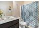 Bathroom with dark vanity, sink, toilet, and patterned shower curtain at 3300 Allison Cir, Decatur, GA 30034