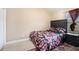 Bedroom featuring a floral patterned bed set, side table, and window blinds at 3300 Allison Cir, Decatur, GA 30034