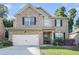 Charming brick two-story home with a well-maintained front yard and two car garage at 3300 Allison Cir, Decatur, GA 30034