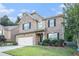 Attractive brick home with landscaped front yard, dark shutters, and an attached two-car garage at 3300 Allison Cir, Decatur, GA 30034