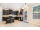 Well-lit kitchen featuring dark cabinets, stainless appliances, and an adjacent breakfast area at 3300 Allison Cir, Decatur, GA 30034