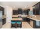 Spacious kitchen with granite countertops, stainless appliances, dark wood cabinetry, and island seating at 3300 Allison Cir, Decatur, GA 30034
