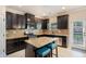 Kitchen features dark wood cabinets, an island with seating, stainless steel appliances and access to outdoors at 3300 Allison Cir, Decatur, GA 30034