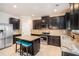 Well-lit kitchen features dark wood cabinets, an island with seating, and stainless steel appliances at 3300 Allison Cir, Decatur, GA 30034