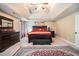 Spacious main bedroom with neutral carpet, tray ceiling, ceiling fan, and stylish décor at 3300 Allison Cir, Decatur, GA 30034