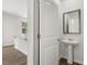 Bathroom featuring a stylish pedestal sink, mirror, and tile flooring at 3941 Fairhaven Rd, Lithia Springs, GA 30122