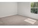 Comfortable bedroom with carpeting, window, and bright neutral color palette at 3941 Fairhaven Rd, Lithia Springs, GA 30122