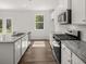 Bright kitchen with stainless appliances, granite countertops, and ample cabinet space at 3941 Fairhaven Rd, Lithia Springs, GA 30122