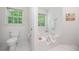 Bathroom offers a soaking tub with tiled walls, natural light, and a toilet at 3 Maplelake Dr, Acworth, GA 30101