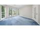 Spacious carpeted bedroom with natural light from multiple windows and a mirrored closet at 3 Maplelake Dr, Acworth, GA 30101
