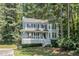 Charming two-story home boasts a covered porch and inviting curb appeal nestled amongst mature trees at 3 Maplelake Dr, Acworth, GA 30101