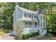 Charming two-story home boasts a covered porch and inviting curb appeal nestled amongst mature trees at 3 Maplelake Dr, Acworth, GA 30101