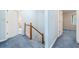 Upstairs hallway with access to multiple bedrooms, carpet and view of staircase at 3 Maplelake Dr, Acworth, GA 30101