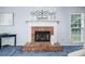 Bright living room with a brick fireplace and hearth, enhanced with elegant decor at 3 Maplelake Dr, Acworth, GA 30101