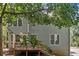Two-story home with a wood deck and steps leading down to the backyard, surrounded by lush greenery at 3 Maplelake Dr, Acworth, GA 30101