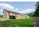 Expansive backyard with green lawn connects the two-story home to the surrounding wooded landscape at 3405 Linstead Ct, Loganville, GA 30052