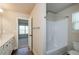 Bright bathroom showcasing a shower-tub combo, neutral wall paint, and an adjacent bedroom at 3405 Linstead Ct, Loganville, GA 30052