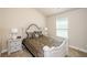 Neutral bedroom features a bed, two side tables and a window at 3405 Linstead Ct, Loganville, GA 30052