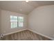 Bedroom featuring a neutral color palette, large window, and comfortable carpeting at 3405 Linstead Ct, Loganville, GA 30052