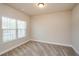 Neutral bedroom with carpeted floors, and a large window with blinds providing natural light at 3405 Linstead Ct, Loganville, GA 30052