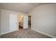 Bedroom with neutral walls/carpet, with entrances to the bathroom and other floors of the home at 3405 Linstead Ct, Loganville, GA 30052