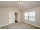 Bedroom featuring an ensuite bathroom, neutral walls/carpet, and a bright, sunny window at 3405 Linstead Ct, Loganville, GA 30052