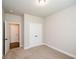 Carpeted bedroom featuring an open door and a closet with double doors at 3405 Linstead Ct, Loganville, GA 30052
