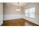 Formal dining room with hardwood floors, wainscoting, and elegant chandelier at 3405 Linstead Ct, Loganville, GA 30052