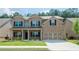Charming two-story brick home with a well-manicured lawn, covered porch, and a two-car garage at 3405 Linstead Ct, Loganville, GA 30052