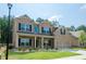 Attractive two-story home with brick and siding exterior, manicured landscaping, and a welcoming facade at 3405 Linstead Ct, Loganville, GA 30052