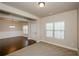 Open living area with neutral carpet, doorway leading to dining room with hardwood floors and chandelier at 3405 Linstead Ct, Loganville, GA 30052