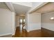 Open-concept space showcasing hardwood floors, chair rail molding and doorway leading to staircase and living area at 3405 Linstead Ct, Loganville, GA 30052