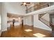 Living room leading into the kitchen and featuring a staircase with iron railing at 3405 Linstead Ct, Loganville, GA 30052