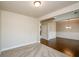 Open living area with neutral carpet, doorway leading to dining room with hardwood floors and chandelier at 3405 Linstead Ct, Loganville, GA 30052