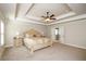 Primary bedroom boasts a tray ceiling, neutral walls, carpet floors, and ensuite bathroom access at 3405 Linstead Ct, Loganville, GA 30052