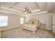 This primary bedroom features an elegant tray ceiling, neutral walls, and plush carpeting at 3405 Linstead Ct, Loganville, GA 30052