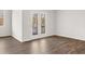 Bedroom with double doors to a balcony and hardwood floors at 3933 Fairhaven Rd, Lithia Springs, GA 30122