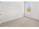 Bedroom featuring plush carpet and a window that overlooks a wooded area at 3933 Fairhaven Rd, Lithia Springs, GA 30122