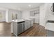 Open kitchen with island, stainless steel appliances, and modern finishes at 3933 Fairhaven Rd, Lithia Springs, GA 30122