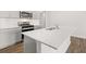 Contemporary kitchen island with white countertops and stainless steel faucet at 3933 Fairhaven Rd, Lithia Springs, GA 30122